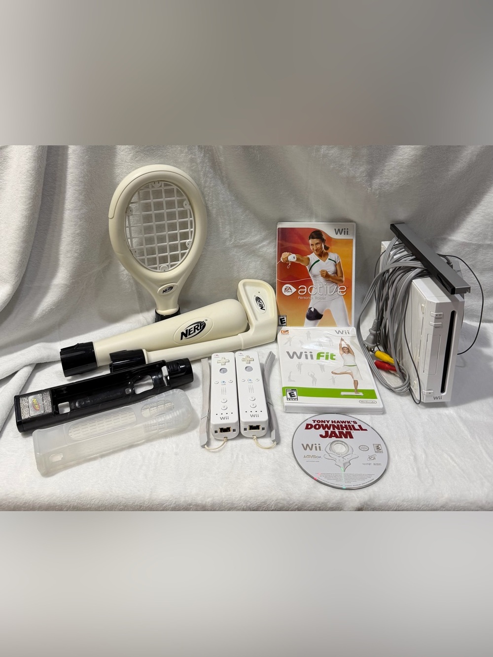 Nintendo Wii console with 2 remotes, 1 silicone sleeve & Nerf sports attachments